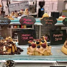 there are many desserts on display in the store