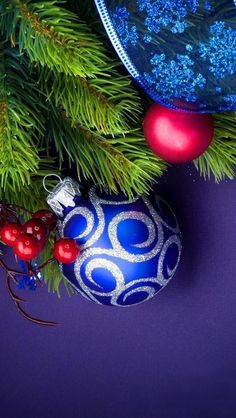 a blue and silver ornament sitting on top of a christmas tree