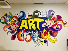 an art mural painted on the side of a white wall with various cartoon characters and letters