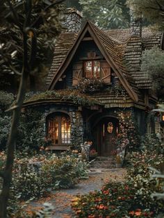 an image of a house in the woods with flowers and trees around it's entrance