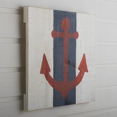 an anchor painted on the side of a white wall next to a blue and red stripe