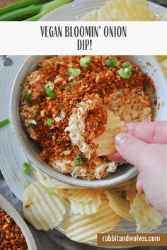 vegan bloom onion dip in a bowl with chips and celery