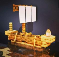 a wooden model of a boat with two mirrors on it's side and a lamp in the middle