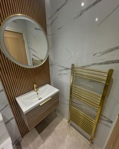 a bathroom with a sink, mirror and radiator next to a toilette