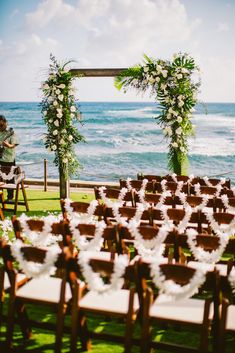 an outdoor ceremony set up by the ocean