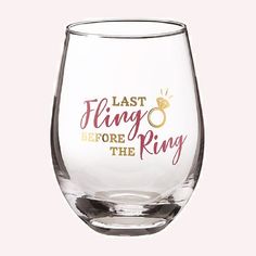 a wine glass with the words last fling before the ring printed on it and gold lettering