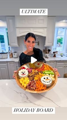 a woman is holding a large platter full of food