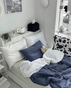 a bed that has some pillows on it