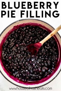 blueberry pie filling in a white bowl with a wooden spoon and text overlay