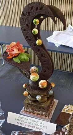 there is a sculpture made out of chocolates and candy on the table next to it