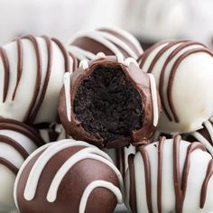 there are chocolate truffles with white frosting on them