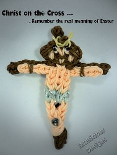 a crocheted cross with the words christ on the cross and an image of a snake