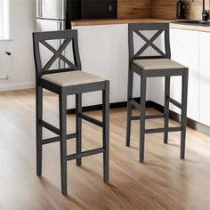 two stools in a kitchen next to a counter