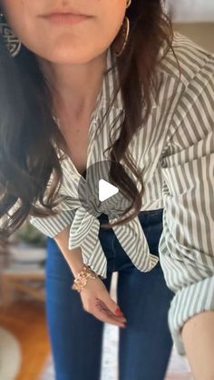 Julia Alexandra on Instagram: "The much requested bow hack for your button up tops. How you get that perfect knot that lays flat is actually...not to make a knot at all. 

Tuck the shirt tails through the bottom two buttons and pull through! It lays flat and you can adjust the waist as you please! 

For the links to the shirt / jeans / shapewear comment "hack" below!" How To Tie A Top Knot, How To Tie A Bottom Up Shirt, Jeans With Long Top, Tie A Shirt Knot Button Up, Jeans Button Down Shirt Outfit, How To Tie A Flannel Shirt Knot, How To Tie A Long Shirt, How To Button A Shirt Hack, How To Tie Shirt Around Waist