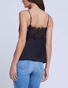 L'Agence Priya Lace Cami in black. Sleeveless. Adjustable spaghetti straps. Lingerie-inspired cami. Black silk charmeuse. Deep V-neckline. Thick lace trim detail. Eyelash-trimmed scallop-edge detail. Semi-fitted design. Unlined. 100% Silk. About 18.75" From Shoulder to Hem. Model Details: Height: 5'10" | Bust: 32" | Waist: 24'' | Hips: 34.5'' | Wearing Size XS. Imported. Chic Camisole With Contrast Lace, Delicate Lace Top With Spaghetti Straps For Night Out, Spaghetti Straps Lace Top For Night Out, Black Satin Camisole With Lace Trim, Evening Cami Tank Top With Lace Trim, Chic Sleeveless Camisole With Contrast Lace, Black Spaghetti Straps Lace Top, Black Evening Camisole With Delicate Straps, Evening Black Camisole With Delicate Straps