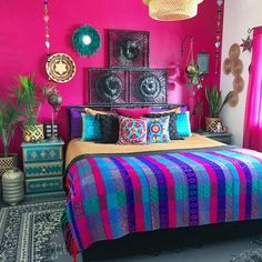 a bedroom with pink walls and colorful bedding in the center, decorated with decorative items