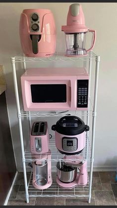 a pink kitchen appliance sitting on top of a shelf