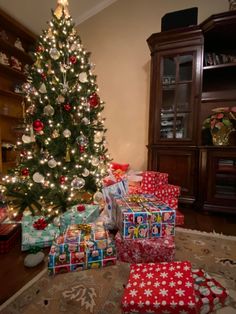 a christmas tree with presents under it