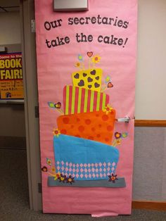 a pink door with a cake on it that says, our secretaryes take the cake