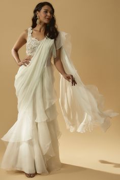 Featuring an ivory draped ruffled saree in chiffon organza base. It is paired with a matching net blouse having thread embroidery. . #perniaspopupshop #ppuslove #whatiworewastrending #sareeset #traditionallook White Ruffle Saree, Organza Saree Draping, Organza Ruffle Saree, Ivory Drapes, Mehendi Decor Ideas, Mehendi Decor, Net Blouse