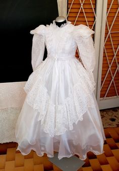 a white dress on display in front of a window