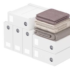 stack of folded towels on top of white boxes