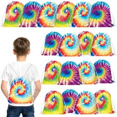 a young boy standing in front of a bunch of tie - dyed bags with different designs