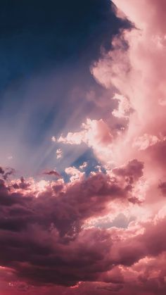 the sky is filled with pink clouds and blue skies