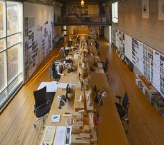 an empty library with lots of books on the shelves and desks lined up in rows