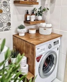 a washer and dryer in a bathroom with shelves on the wall above them