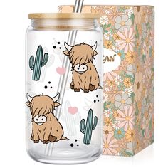 a glass jar with an image of a cow on it and a box behind it