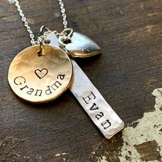 Show your grandparent pride with this grandchild and grandma necklace. 1 1/4" handstamped silver tag in with grandchild's name. Has a brushed satin, hammered finish.  Charm is solid silver alkeme', which is a metal alloy that won't tarnish and is very durable. It is hypo-allergenic and nickel free and made in the USA. 5/8" brass disc stamped "grandma" or any name you prefer... nana, mama, granny, etc. 3/8" silver heart charm. Hangs from a .925 sterling silver chain and is hypo-allergenic and nic Grandma Jewelry, New Grandma Gift, Grandma To Be, First Time Grandma, Personalized Charm Necklace, Grandma Necklace, Christmas Gifts For Grandma, New Grandma, Jewelry Care Instructions