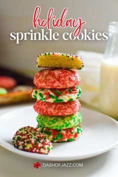 holiday sprinkle cookies stacked on top of each other in front of a bottle of milk