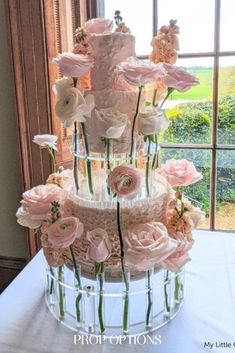 a wedding cake with pink flowers on top