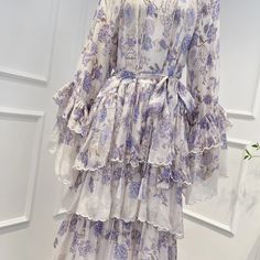 a white dress with purple flowers on it