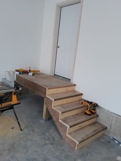 a room with some stairs and tools on the floor