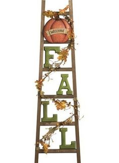 a wooden ladder with the word fall written on it and an orange ball in the center