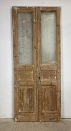 an old pair of wooden doors with frosted glass