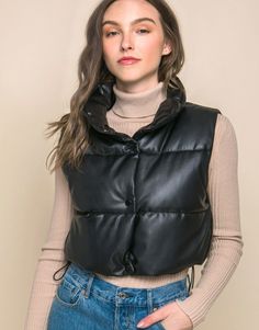 Add a touch of edgy style to your casual outfits with our Faux Leather Puffer Vest. This trendy puffer vest is perfect for layering over your favorite tops. This is a versatile and must-have addition to your casual wardrobe, perfect for staying warm and fashionable during cooler days.PRODUCT SPECIFICATIONS*100% Polyurethane*Brand: Love Tree*Model is wearing a size Small Edgy Black Vest For Fall, Fall Streetwear Vest, Fall Streetwear Solid Color Vest, Solid Color Fall Streetwear Vest, Fall Cold Weather Vest With Padded Collar, Fall Vest With Padded Collar For Cold Weather, Padded Collar Vest For Cold Weather In Fall, Versatile Fitted Winter Vest, Trendy Sleeveless Vest For Cold Weather