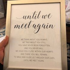 a person holding up a framed print with the words until we met again