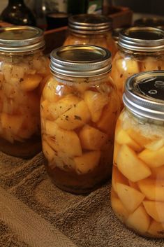 several jars filled with pickled potatoes sitting on a towel