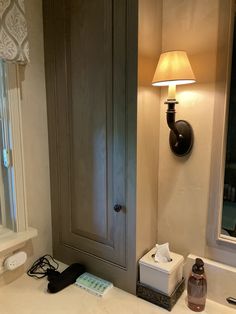 a bathroom with a sink, mirror and medicine cabinet in it's center area