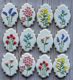 nine decorated cookies with flowers on them