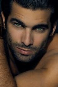 a close up of a man with green eyes