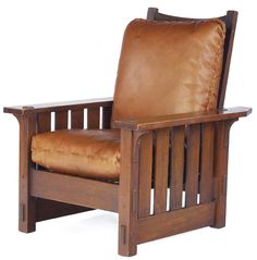 a wooden chair with brown leather cushions