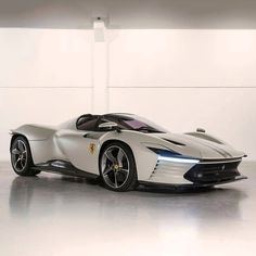 a white sports car parked in a garage