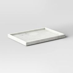 a white marble tray sitting on top of a table