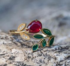 "Flower ring with ruby in 14k gold. Pear ruby ring. Berry ring with ruby. Gold Leaves ring with diamonds. Open Ended Ring with ruby. By Daizy Jewellery. \"Floral\" ring with Enamel Green Leaves with natural ruby, diamonds   Metal type: Gold Metal stamp: 14k Gold Gemstones  Natural Ruby: pear shape, red color, VS-Si clarity, 1 piece 0.80-0.90 ct Surrounding stone - diamond (4 pieces x 0.01) total 0.04 ct (G/Vs), round brilliant cut. Some leaves are covered with enamel. 💍This ring will be made for order 💍Processing time for custom item takes: 5-7 working days. 💍 It could be done in any size - you can choose on menu 💍 Color and type of the stones could be changed 💍Made in Solid 14K Gold, in your choice of color: Rose, Yellow, White  💎 We use only NATURAL gemstones. 🎁 All pieces come be Ruby And Emerald Ring, Gold Twig Ring, Ring With Ruby, Star Ruby Ring, Leaves Ring, Gold Leaf Rings, Expensive Diamond, Ring Jewellery Design, Ruby Ring Gold