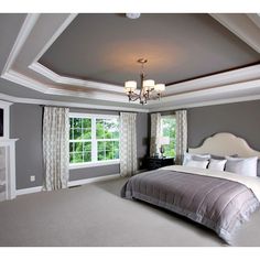 a bedroom with a large bed and fireplace in it