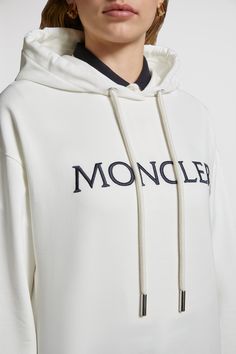 A Moncler classic, this hoodie is embellished with an embroidered logo across the chest. The loose fit sweatshirt is crafted from lightweight jersey and fleece. Luxury Cotton Hoodie Sweatshirt, Luxury Long Sleeve Hoodie With Logo Print, Luxury Long Sleeve Hoodie With Ribbed Cuffs, Athleisure Hoodie Sweatshirt With Logo Detail, Luxury Cotton Sweatshirt With Embroidered Logo, Luxury Logo Long Sleeve Sweatshirt, Luxury Long Sleeve Logo Sweatshirt, Luxury White Cotton Sweatshirt, Luxury Cotton Sweatshirt With Logo